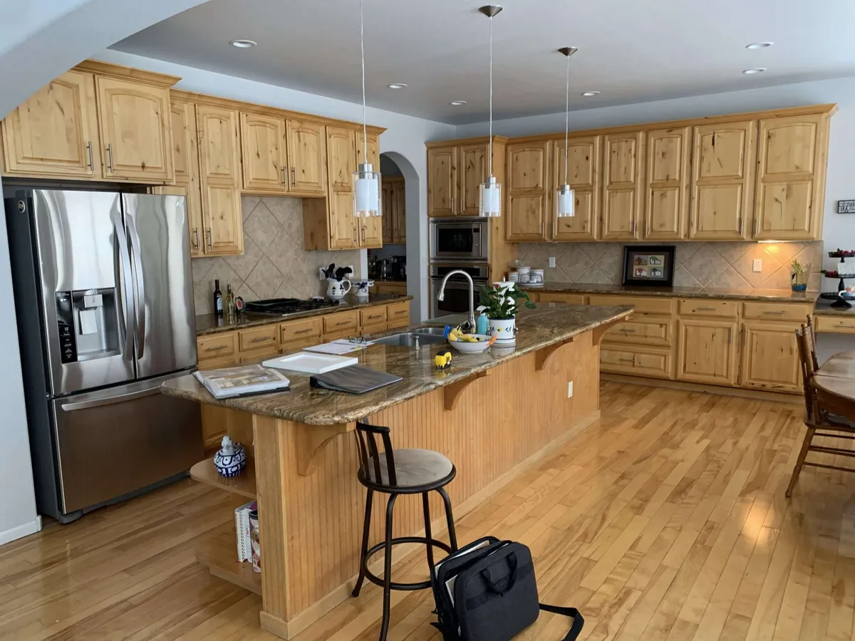 Honey-toned kitchen cabinets before refinishing