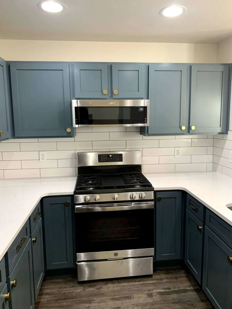 The same cabinetry in slate blue with brass hardware