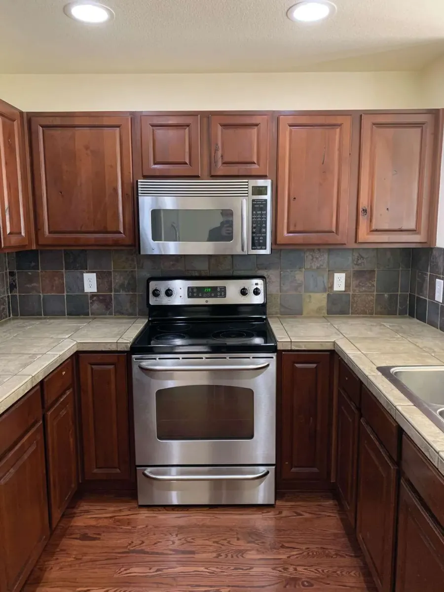 Dark cherry-toned cabinets before refinishing
